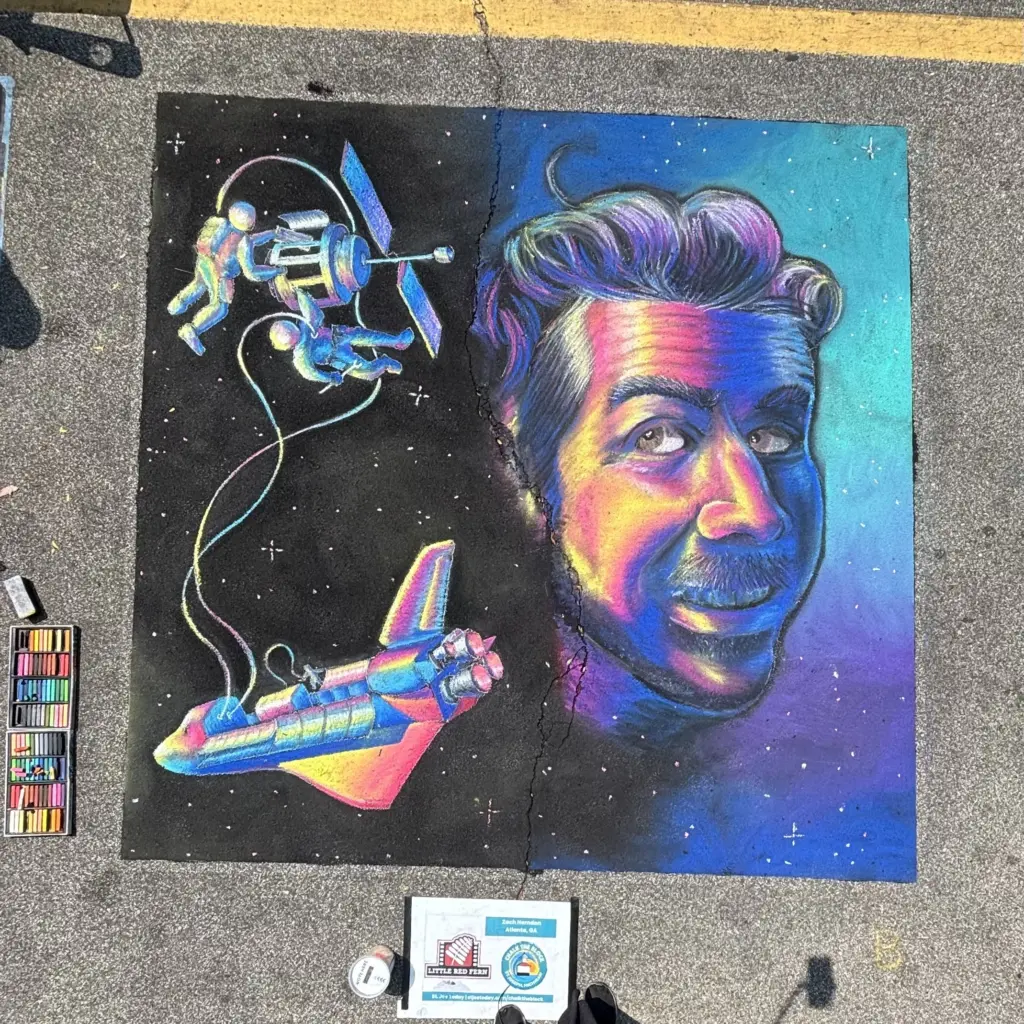 Chalk portrait of a smiling man with wavy hair in neon pink, orange and blue, beside astronauts on a spacewalk and a rainbow-colored space shuttle.